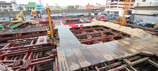 Building construction site in the city. Underground foundation for high-rise building. Metal...