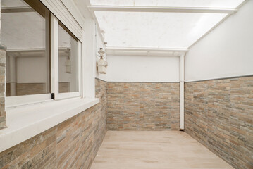 Drying terrace with white aluminum windows and glass in the kitchen of an apartment and semi-transparent plastic ceiling