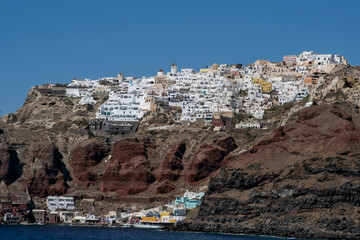 View of the picturesque village of Oia and the the famous Ammoudi harbour in Santorini Greece