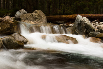 Waterfall flowing through rocks formation. Peaceful close up view with long exposure.