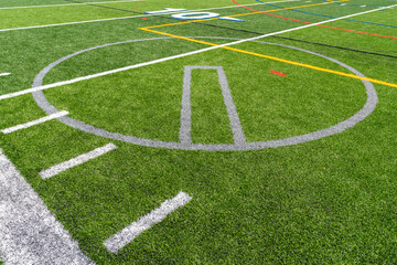 Synthetic turf multi sport field with soccer, football, lacrosse and softball pitching circle lines...