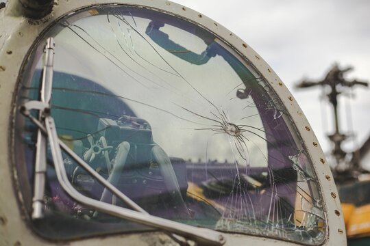 Closeup shot of bullet holes on the glass of a MI24 helicopter