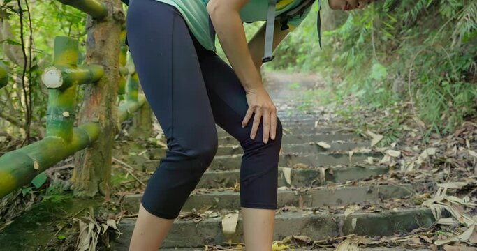 woman hiking on mountain stairs