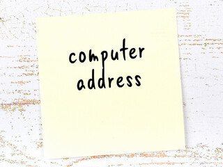 Yellow sticky note on wooden wall with handwritten word computer address - obrazy, fototapety, plakaty