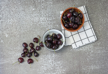 Two bowls with cherries on the table