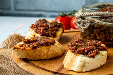 Bacon jam spread on a toasted baguette, close-up.