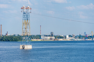 Electricity transmission towers and power lines. High voltage pole on the river. Energy concept in...