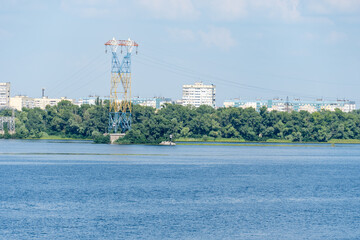 Electricity transmission towers and power lines. High voltage pole on the river. Energy concept in...