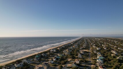 Aerial view of sea waves crashing into the sandy beach of Outer Banks island North Carolina