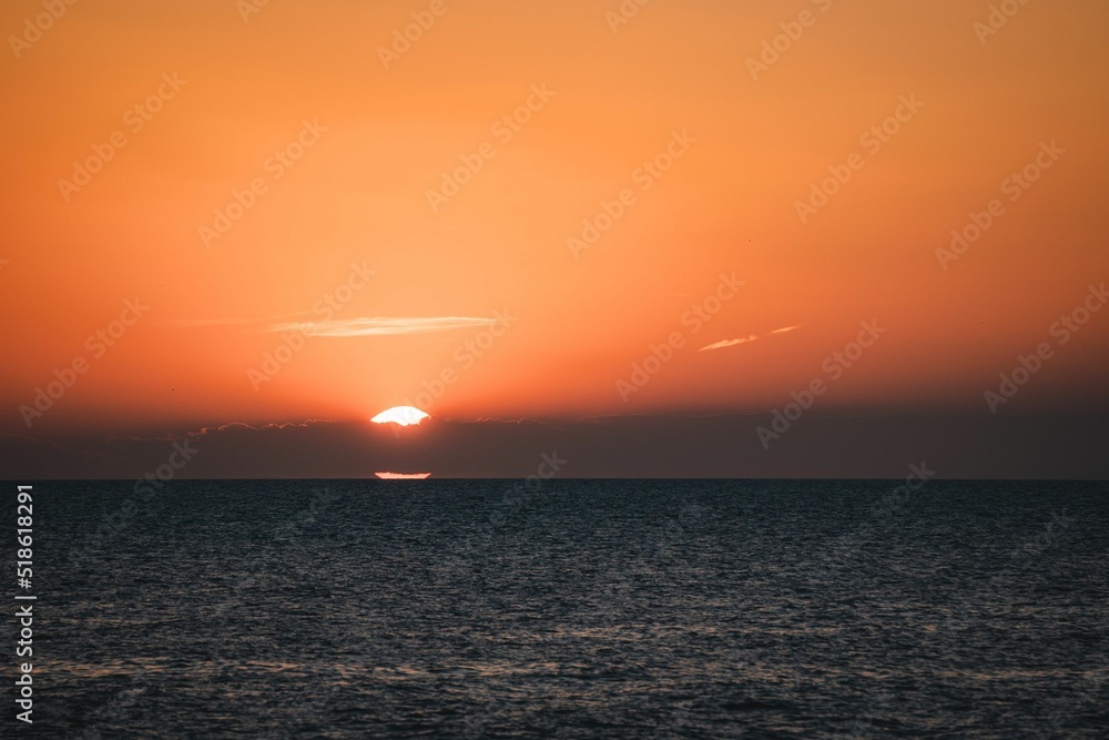 Wall mural Bright orange sunset sky over a sea in Rovinj, Croatia