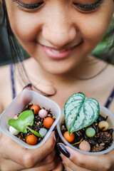 Closeup of Happy Beautiful Exotic Asian Teen Girl Holding Tiny Tropical Leaves