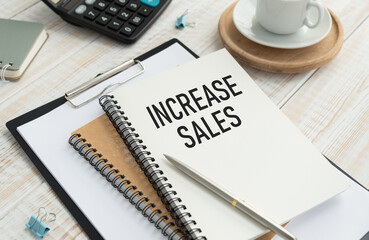 Increase Sales text on notepad on wooden table