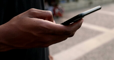 African man using cellphone in city