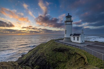 Beautiful shot of the North Head Lighthouse on a hill at sunset in Ilwaco, Washington