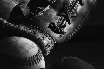Retro grunge baseball glove with ball for sports equipment closeup in black and white.