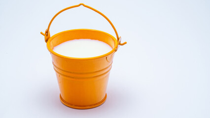 full bucket of milk on a white background © Oleg