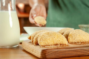 Brazilian meat stuffed croquette (risolis de carne) on a wooden table.