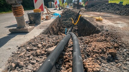 Construction site with a dug road for laying new water pipes