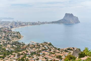 Aerial view of the sunny shore of Calpe with houses in Costa Blanca, Spain