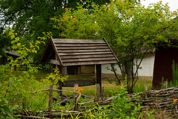 Old Well on the background of the house