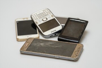 Close-up shot of disposed damaged smartphones