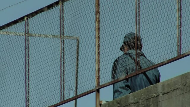 A Prison Officer walking Along a Walkway in an Old Prison in Buenos Aires Province, Argentina.