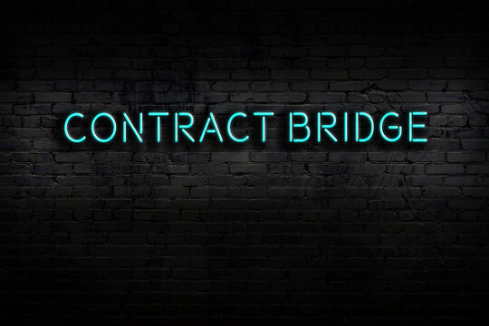 Night View Of Neon Sign On Brick Wall With Inscription Contract Bridge