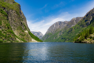 Naklejka na ściany i meble Impressive fjord between mountains with waterfalls and all green, in Gudvangen - Norway