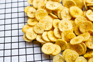 Banana slice chips on white background.