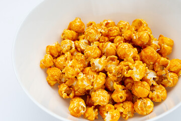 Honey caramel popcorn on white background.