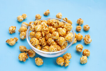 Honey caramel popcorn on blue background.