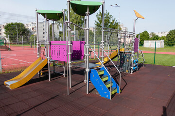 Colorful children playground near sports field stadium in the city