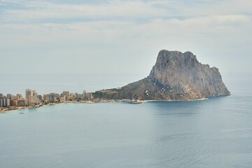 Aerial view of a cliff and the Calpe skyline over the water in Spain