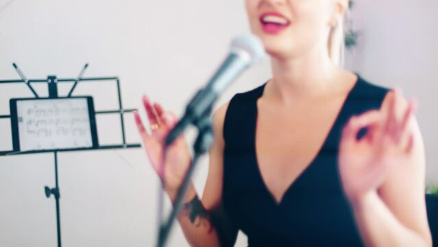 4k beautiful woman singing and playing piano. Emotional female vocalist and musician. Training tutorial in white studio. Rehersal performance voice training. 