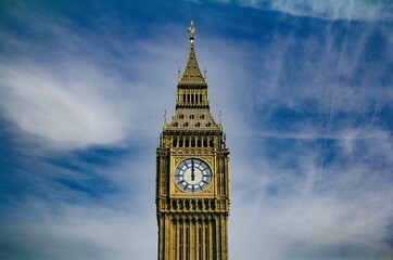 Big Ben Tower on a sunny day in London, the United Kingdom, on a sky background