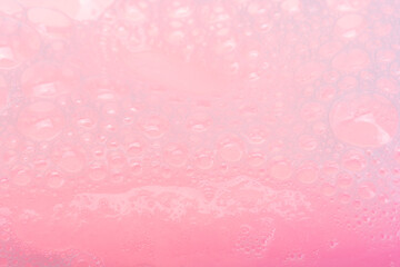 pink soap suds background closeup