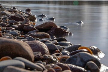 Closeup shot of wet pebbles on the coast of a lak