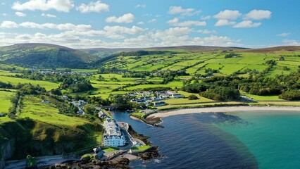 Aerial view of green valleys and pastures on the shore of Northern Ireland