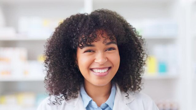 A friendly pharmacist working in a pharmacy. Happy African woman with afro smiling and looking confident while working in a drugstore. Woman enjoying her career in the healthcare industry