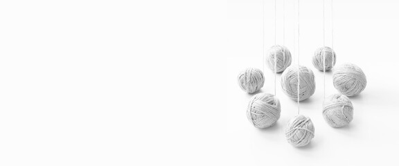 balls of white yarn unwinding from a perspective, on an isolated white background