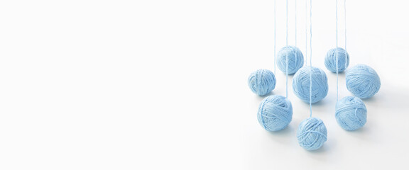 balls of blue yarn unwinding from a perspective, on an isolated white background