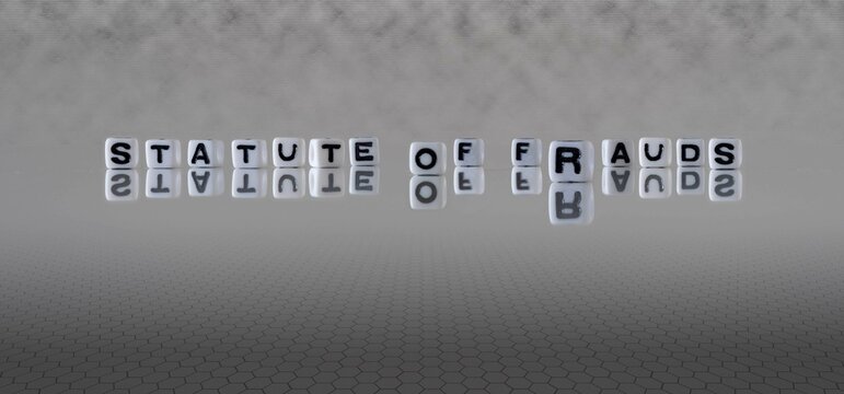 statute of frauds word or concept represented by black and white letter cubes on a grey horizon background stretching to infinity