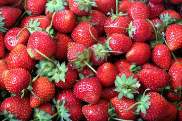 Crop from many red ripe strawberries as background top view close up