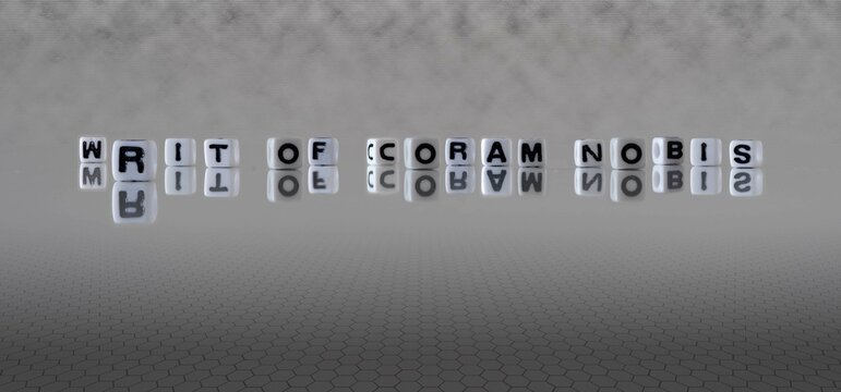 writ of coram nobis word or concept represented by black and white letter cubes on a grey horizon background stretching to infinity