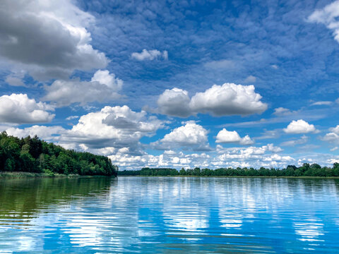 landscape of lakes in Poland, Masuria, a picture for a postcard, water, forests, beautiful sky