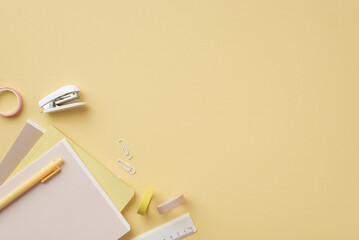 Back to school concept. Top view photo of stationery diaries pen ruler clips mini stapler and adhesive tape on isolated pastel yellow background with copyspace - obrazy, fototapety, plakaty