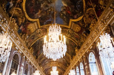 Beautiful shot of the ceiling with chandeliers in the Europe Versailles