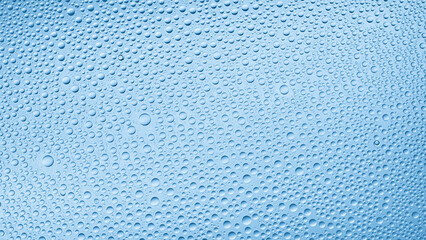 Water drops on the wet glass surface on blue background | Background for beauty care moisturizing products