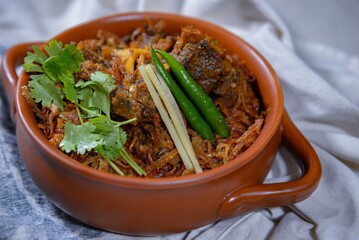Spicy bhuna goshat served in a dish isolated on dark background side view