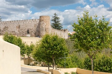 View of the trees against the Castle of Sines on a sunny day